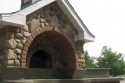 All masonry Wood Fired Oven with green concrete countertop, local fieldstone, brick and ceramic tile on chimney