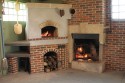 From left: wood fired pizza oven with wood storage below, wood burning fireplace