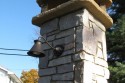 Beautiful lit chimney for outdoor bake oven by Stichter & Sons Masonry.