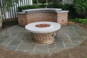 Bluestone patio, tapered brick fire ring base, curved countertop support/ grill support with bluestone toe kick